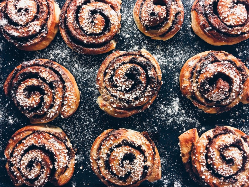 cinnamon buns dusted with icing sugar